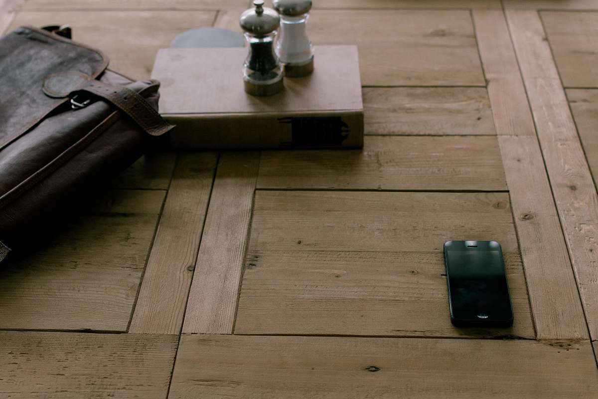 cell phone black smartphone beside brown leather bag mobile phone